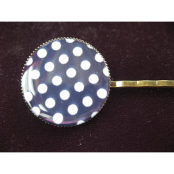 Fancy hair clip, white dots, on a black background