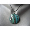 Graphic pendant, black and white patterns, on a turquoise Fimo background