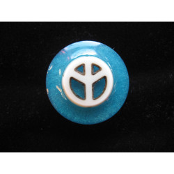 Fancy ring, white peace and love cabochon, on a turquoise resin background