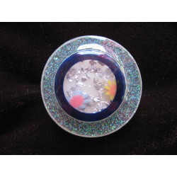 Large graphic ring, transparent blue cabochon with flowers, on a pearly white resin background