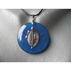 Graphic pendant, silver charm, on blue resin background