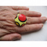 Graphic ring, red and orange polka dots, on a yellow Fimo background